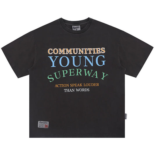 Flat lay of gray "actions speak louder than words" slogan graphic t-shirt