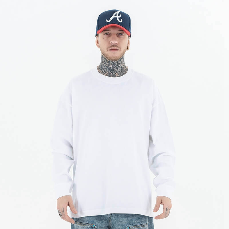 Model wearing front view of classic crew neck solid color custom long sleeve t-shirt.