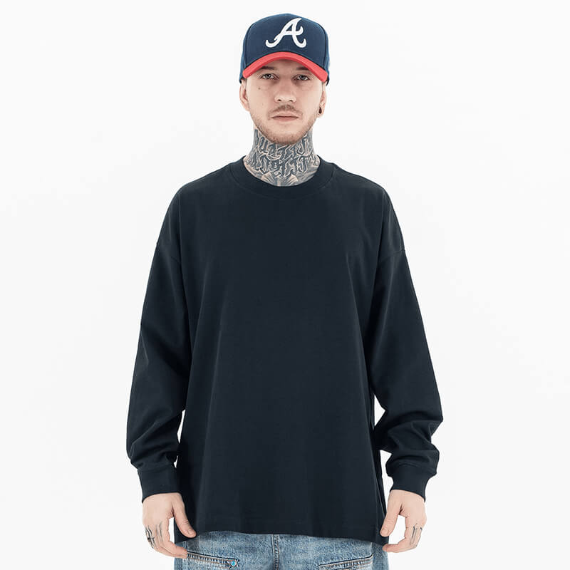 Model wearing front view of classic crew neck solid color custom long sleeve t-shirt.