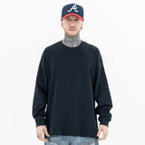 Model wearing front view of classic crew neck solid color custom long sleeve t-shirt.
