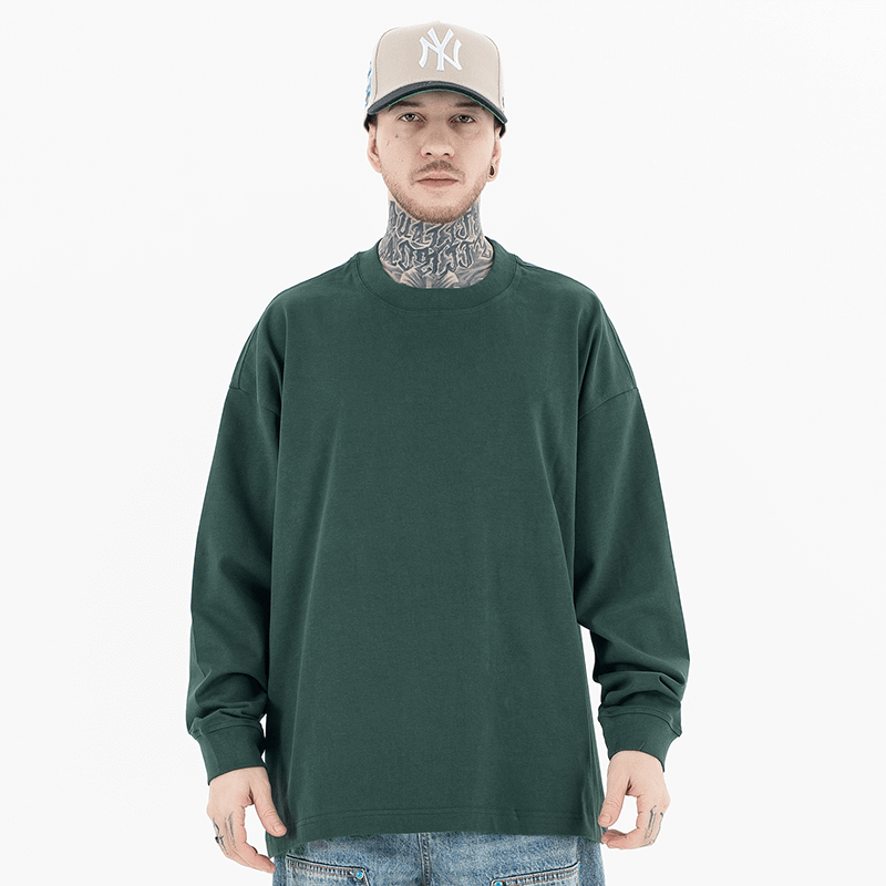 Model wearing front view of classic crew neck solid color custom long sleeve t-shirt.