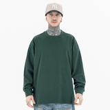 Model wearing front view of classic crew neck solid color custom long sleeve t-shirt.