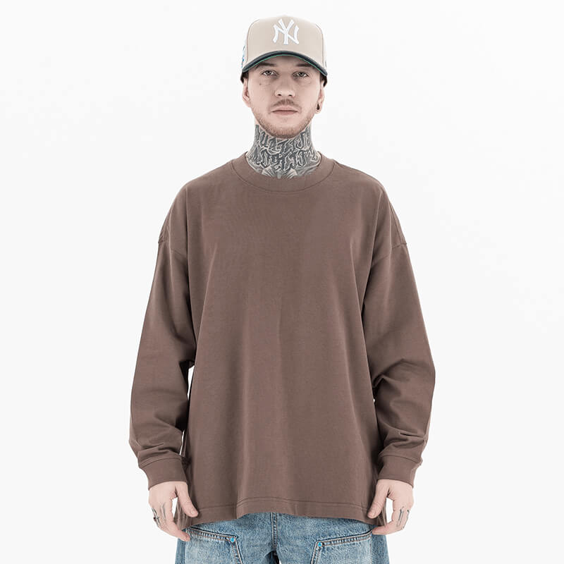 Model wearing front view of classic crew neck solid color custom long sleeve t-shirt.