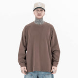 Model wearing front view of classic crew neck solid color custom long sleeve t-shirt.