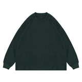 Flat lay of green classic crew neck solid color custom long sleeve t-shirt.