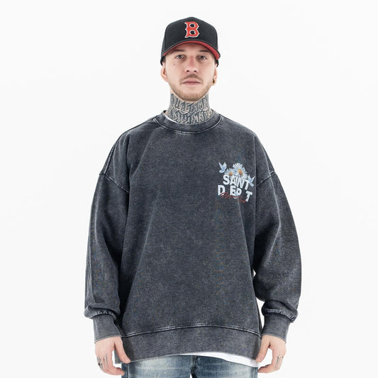 Front view of a model in a vintage floral graphic sweatshirt