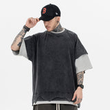 Front view of a model wearing a double collar solid color T-shirt.