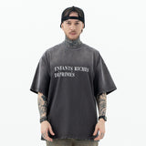 Model wearing front view of enfants riches deprimes vintage washed classic logo graphic t-shirt.