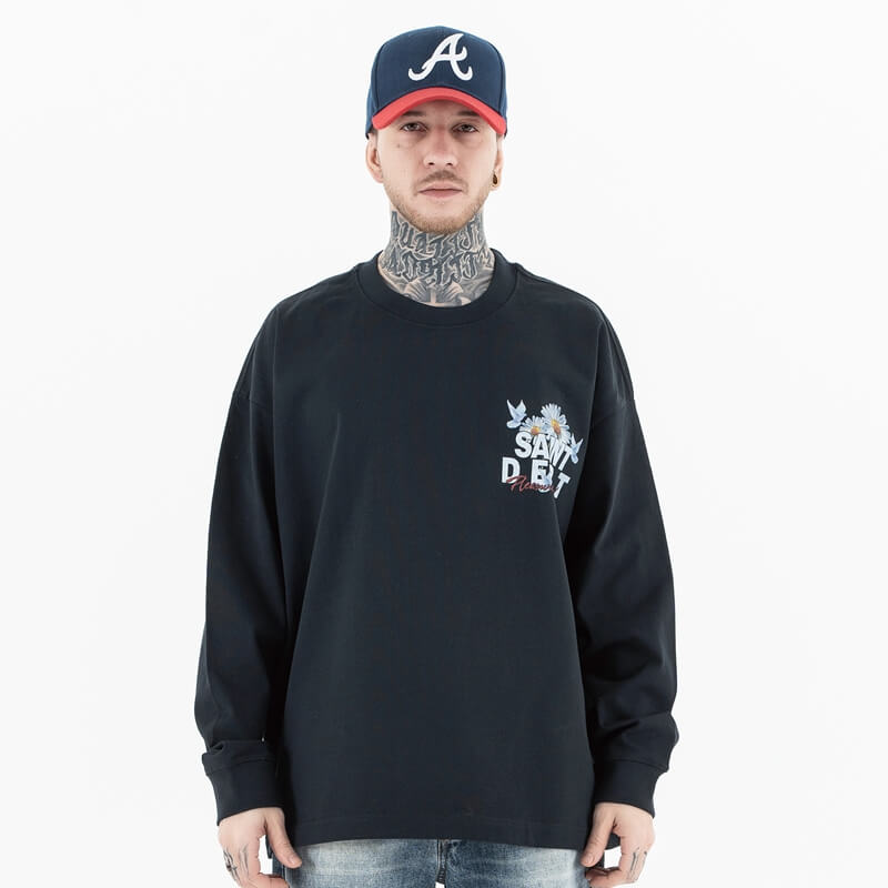 Front view of a model wearing a washed floral long sleeve graphic T-shirt