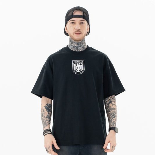Model wearing front view of kanye west vultures graphic t-shirt.