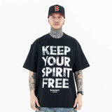 Front view of a model wearing a 'Keep Your Spirit Free' cotton graphic T-shirt