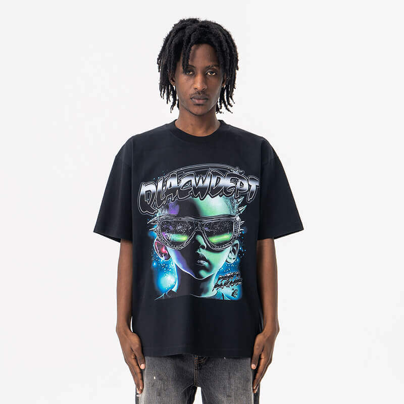 Model wearing front view of black qlacw brand street fashion graphic t shirt.