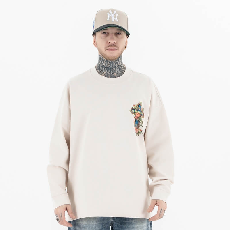 Front view of a model wearing a QLACW logo street cross long sleeve T-shirt