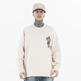 Front view of a model wearing a QLACW logo street cross long sleeve T-shirt