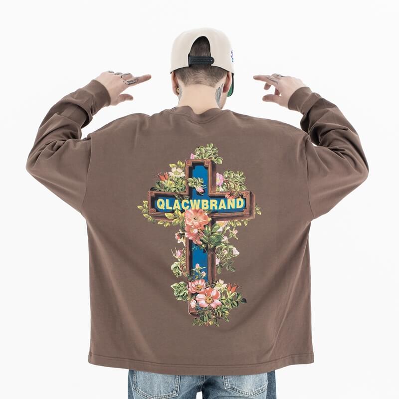 Back view of a model wearing a QLACW logo street cross long sleeve T-shirt