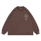 Flat lay of a QLACW logo street cross long sleeve graphic T-shirt