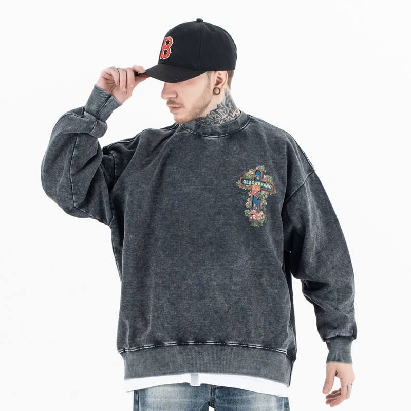 Front view of a model wearing a 'QLACW' vintage street graphic sweatshirt