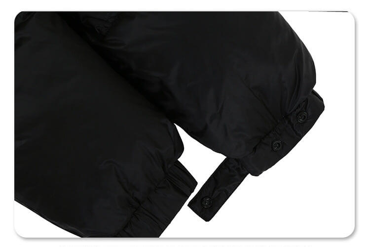 Sleeve detail of solid color oversized stand collar zipper padded jacket.
