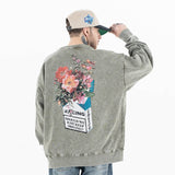 Back view of model wearing a vintage wash crew neck flower graphic sweatshirt.