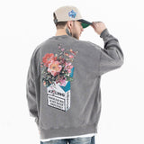 Back view of model wearing a vintage wash crew neck flower graphic sweatshirt.
