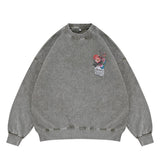 Flat lay of a green vintage wash crew neck sweatshirt with a floral graphic design.