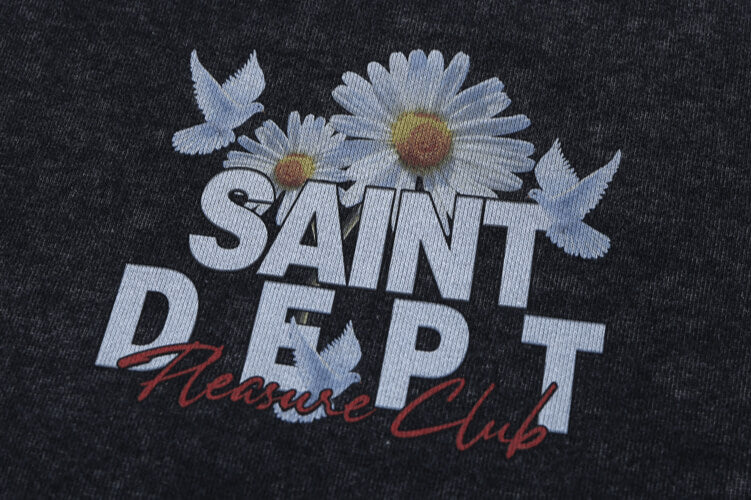 Close-up of vintage wash saint hoodie graphic details.